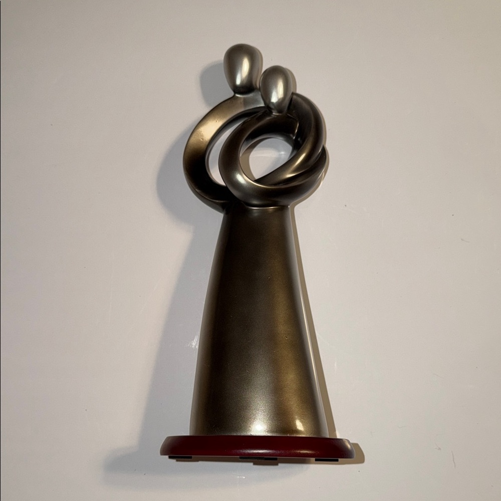 Silver Abstract Sculpture Representing a Hugging Couple.  Colored Resin 12” High